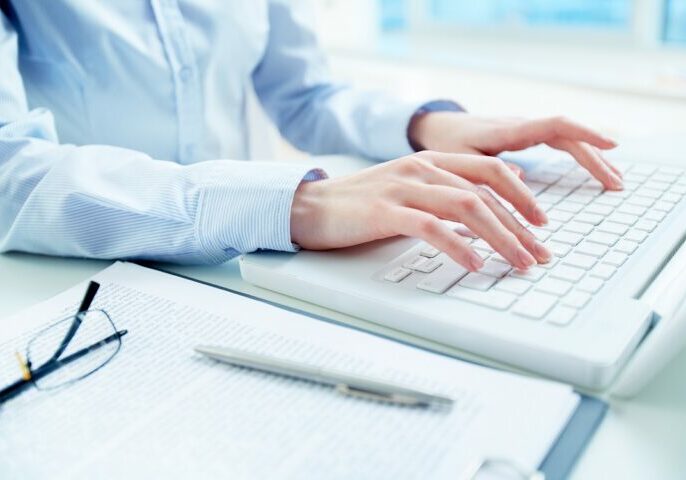 Hands of an office woman typing