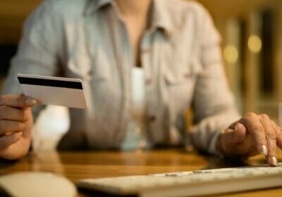 closeup-woman-using-computer-credit-card-online-banking-evening-home (1)