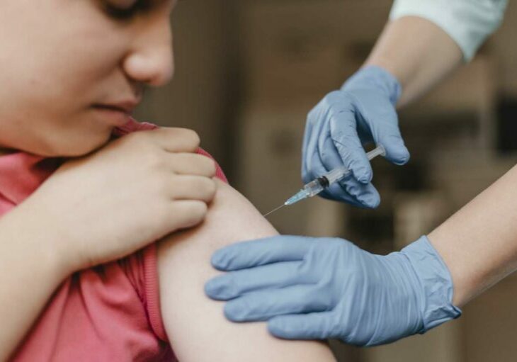 doctor-wearing-gloves-giving-kid-vaccine