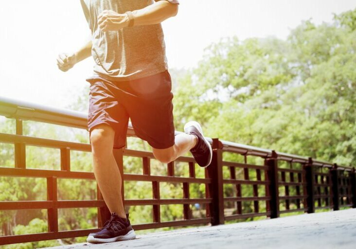 Runner man. Health and fitness outdoor concept. Man is jogging in  the morning. Young man doing sports and jogging in a park.