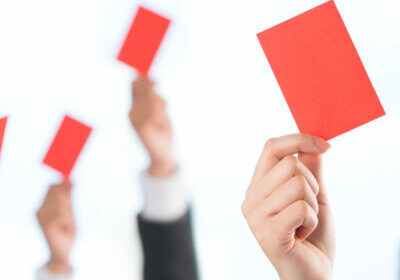 Cropped image of human hands declining something showing red card on the foreground