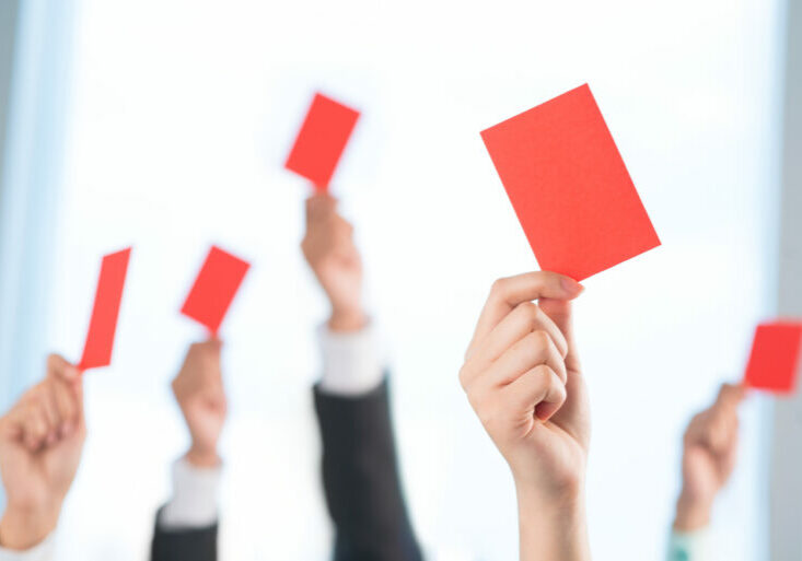 Cropped image of human hands declining something showing red card on the foreground