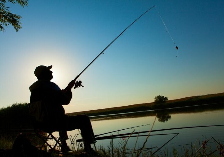 Young man fishing on a lake